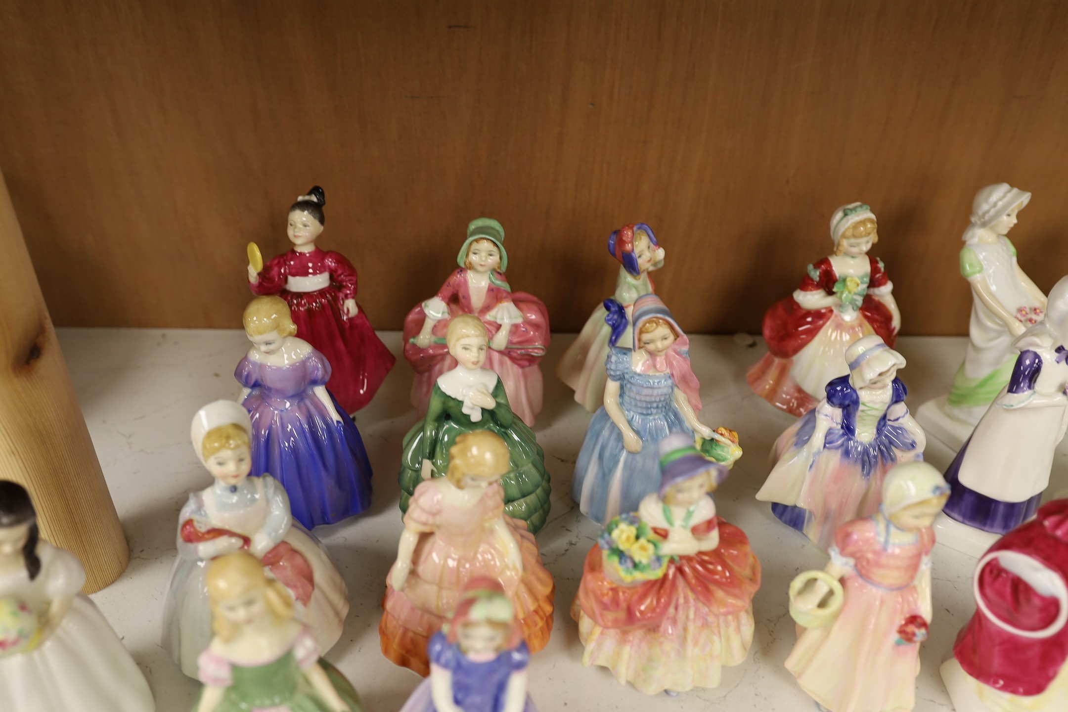 A collection of twenty five Royal Doulton figurines; Mandy, Penny, Ivy, the Rag Doll, Rose, Cissie, Tinkle Bell, Georgina, Julie, Andrea, Francine, Goody Two Shoes, Catherine, Helen, Anna, Dinky Do, Wendy, Belle, Marie,